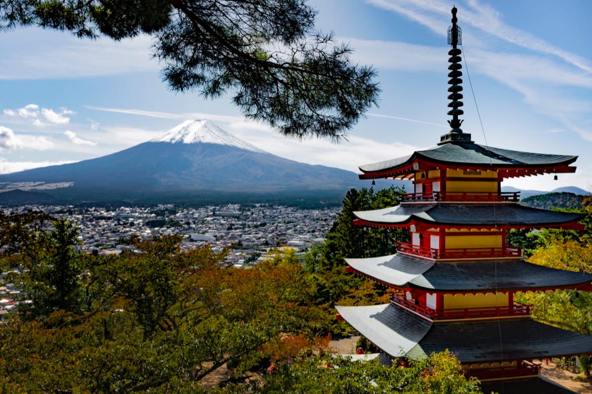 Chureito Pagoda with snow-capped Mount Fuji in the background and town in the valley