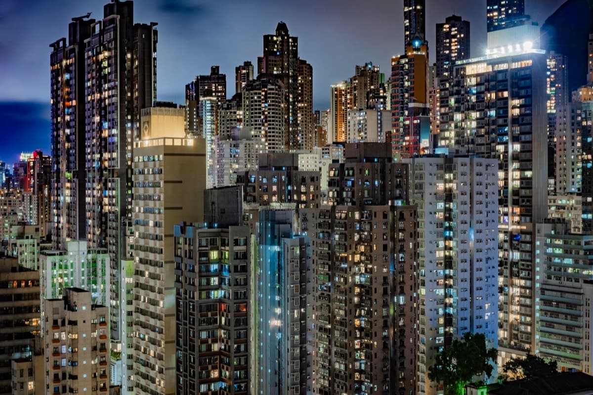 Dense cluster of illuminated high-rise residential towers at night