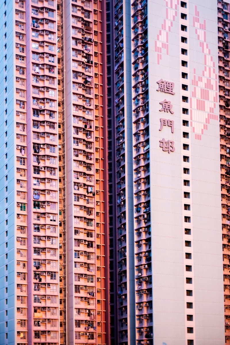 Colourful public housing tower facades with Chinese characters reading Lei Yue Mun Estate