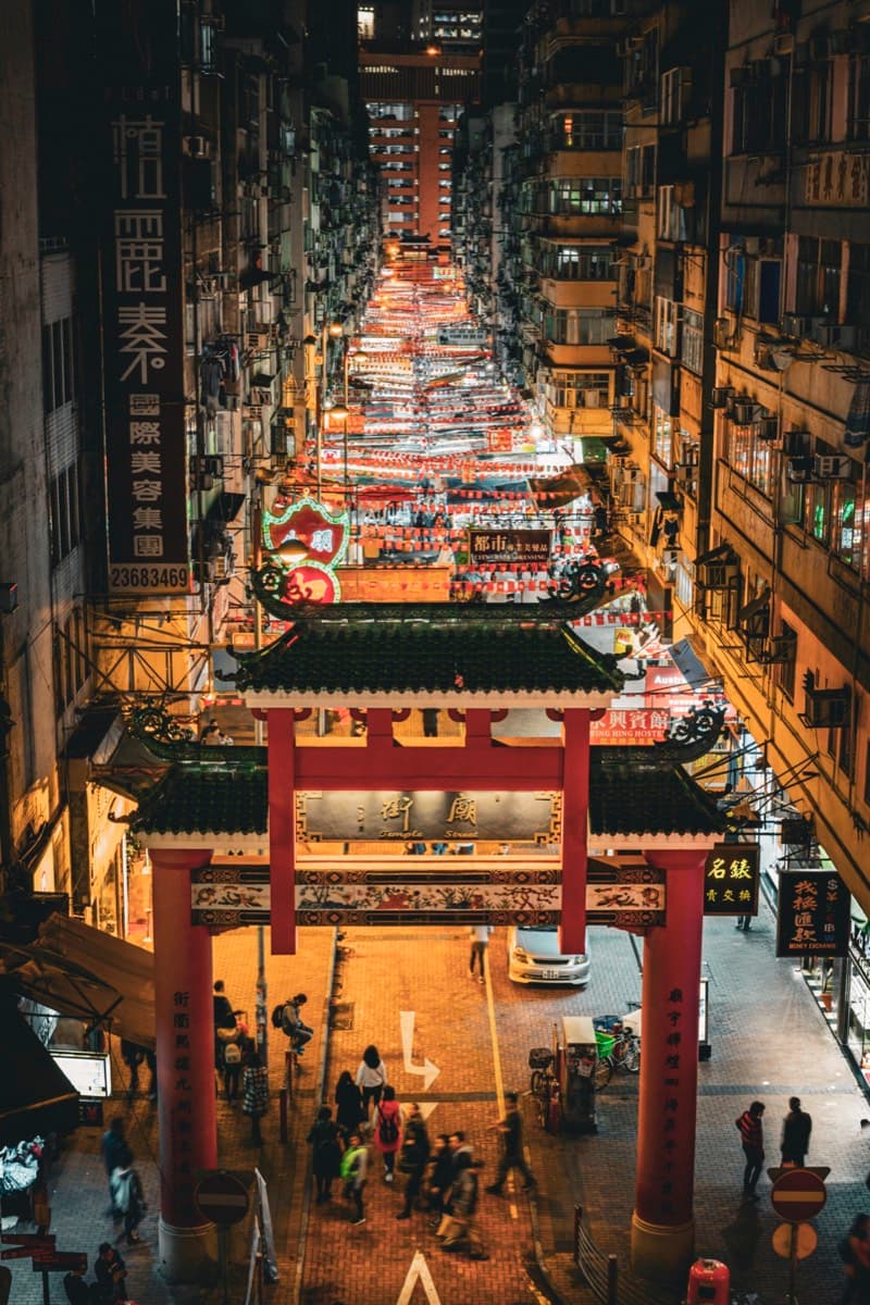 Elevated view through a Chinese gate looking down at Temple Street Night Market