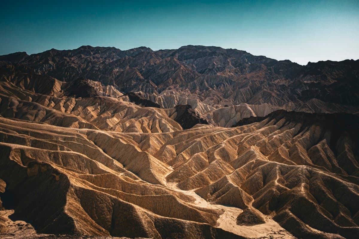 Eroded desert badlands with folded ridges and barren mountains at Zabriskie Point